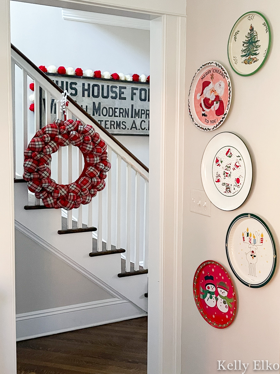 Love the whimsical vintage Christmas tray gallery wall in this stunning home tour kellyelko.com