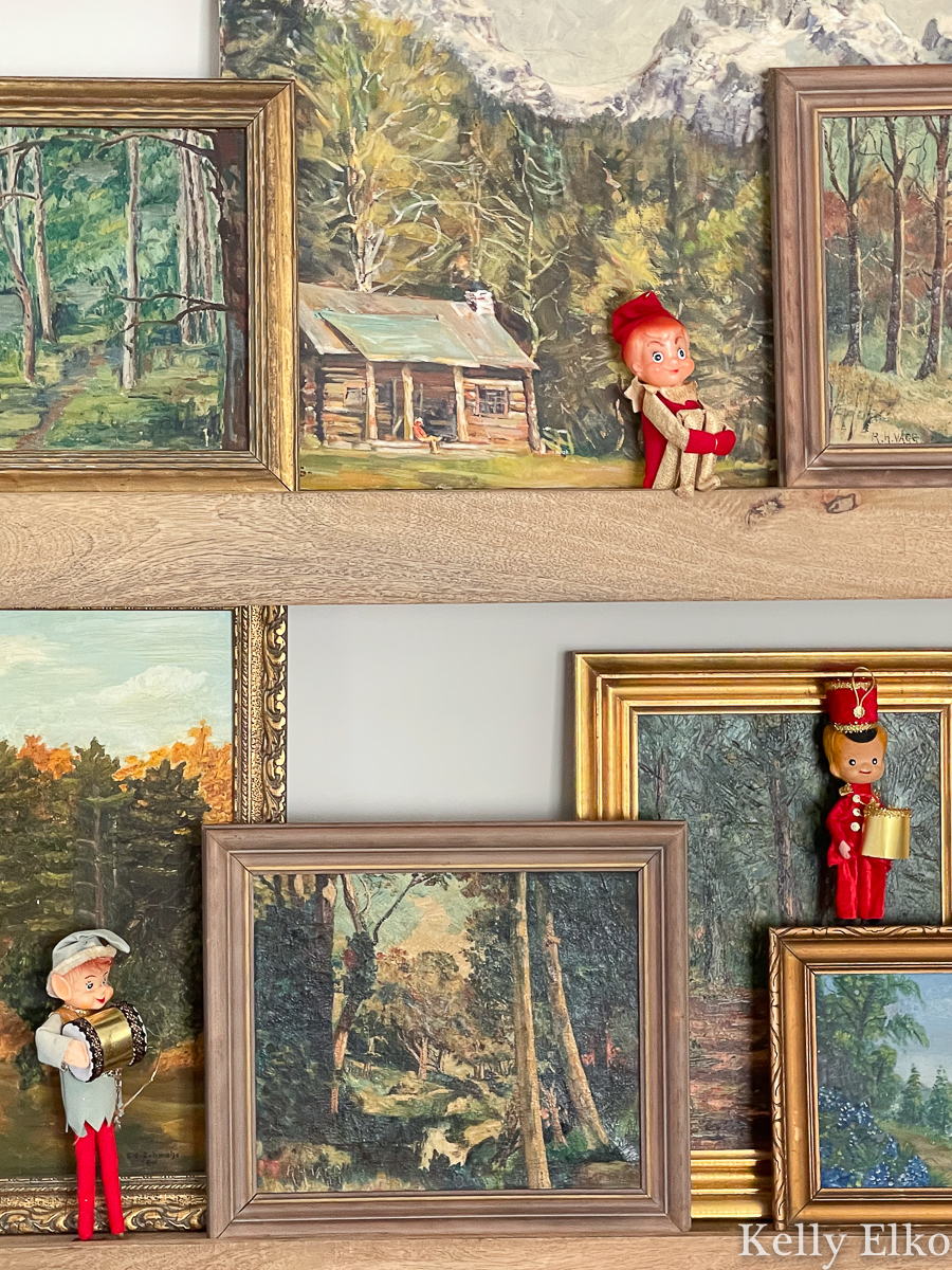 Cute little elf knee huggers displayed among vintage paintings for Christmas kellyelko.com