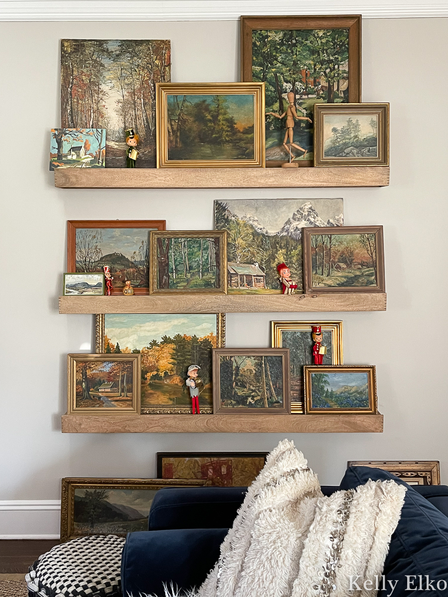 Love this vintage landscape gallery wall with little elves for Christmas kellyelko.com