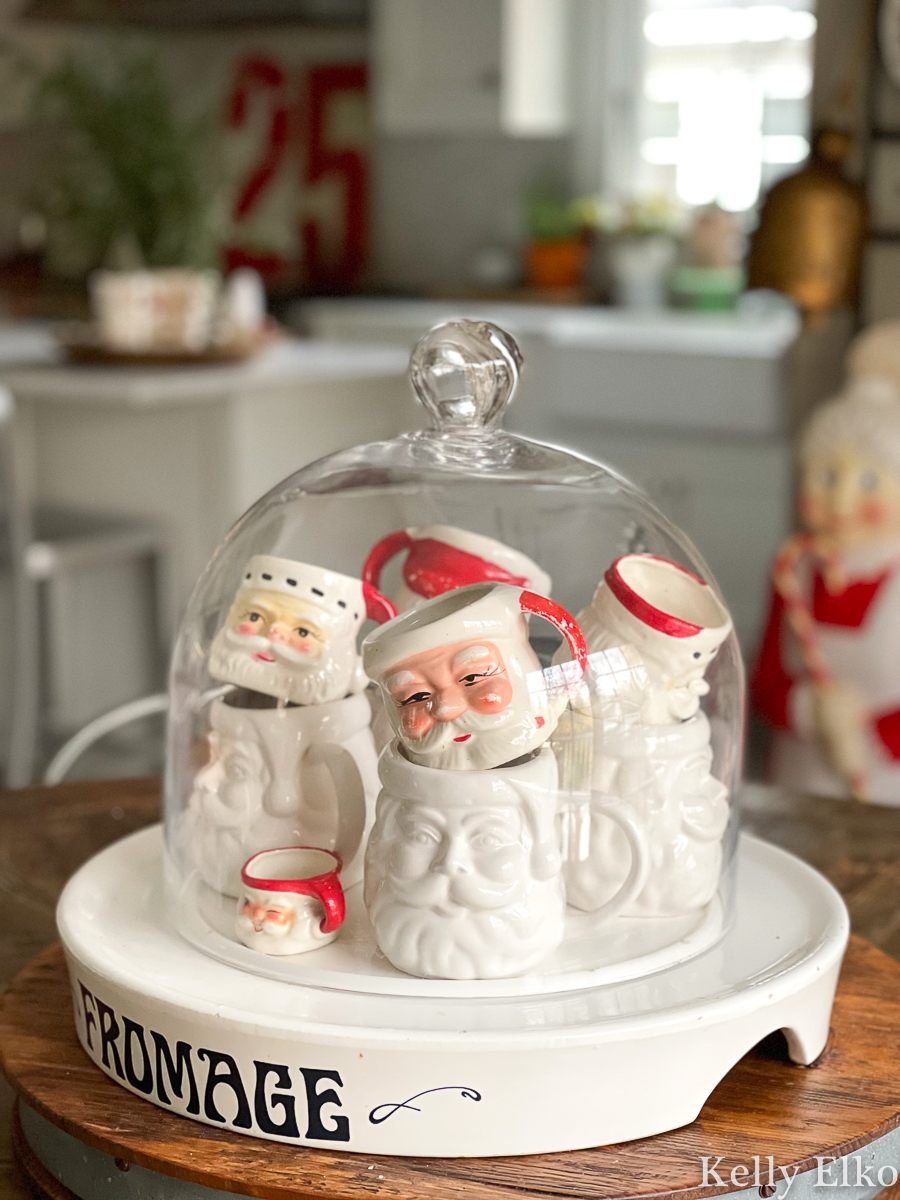 Love this collection of Santa mugs under glass kellyelko.com