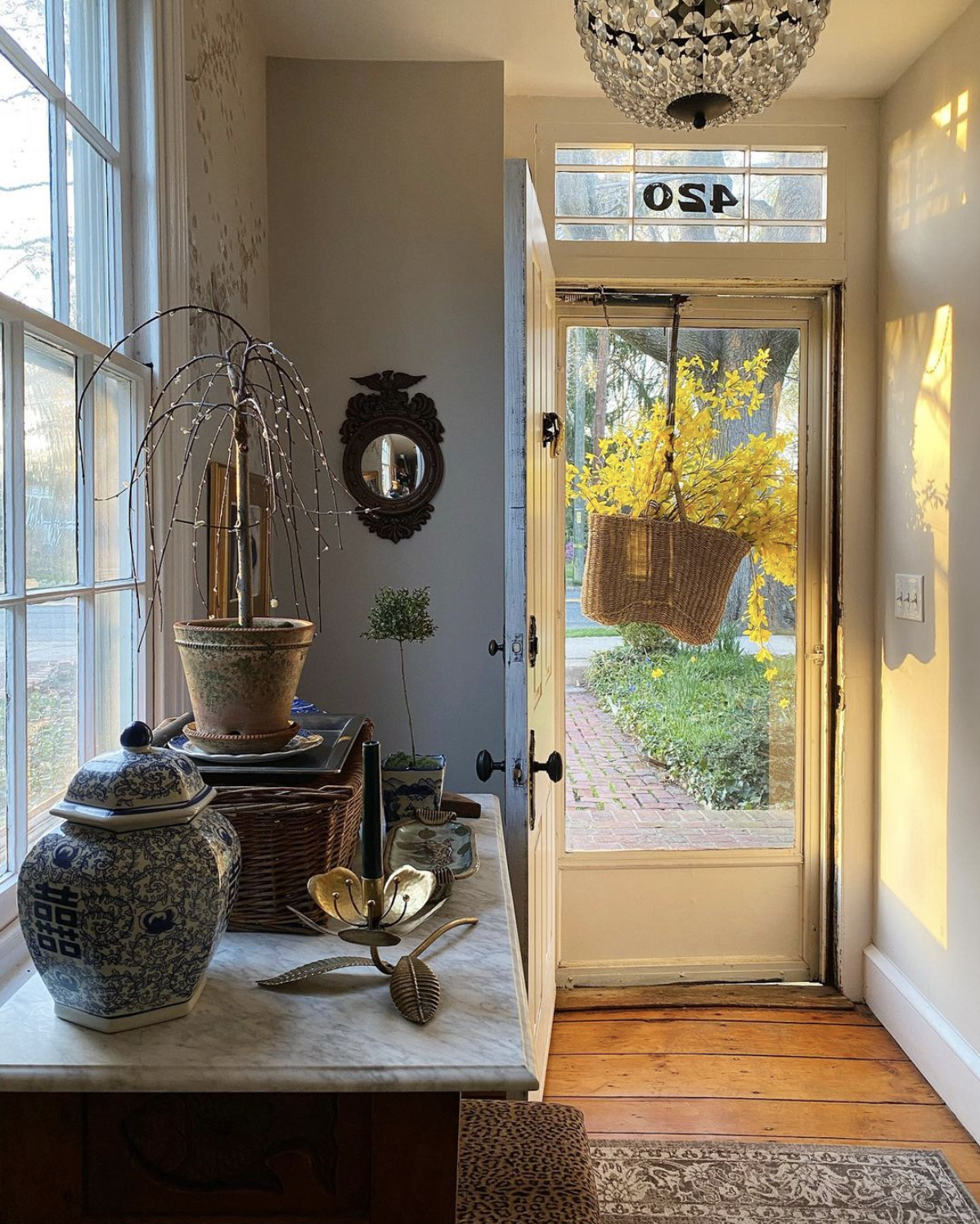 Beautiful foyer with antique furniture and basket wreath on front door kellyelko.com