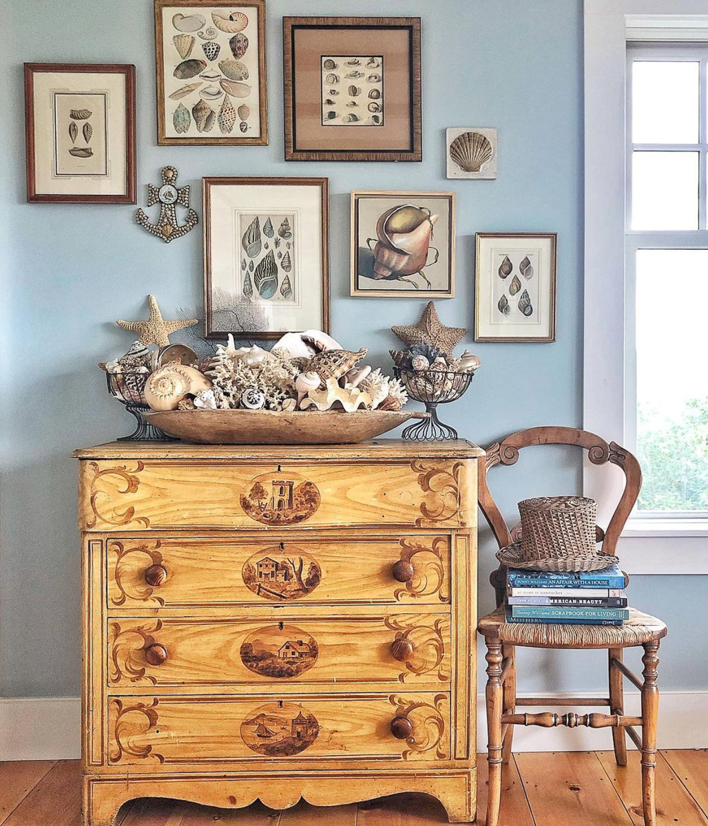 Antique shell art and a huge dough bowl filled with shells and coral in this coastal home kellyelko.com