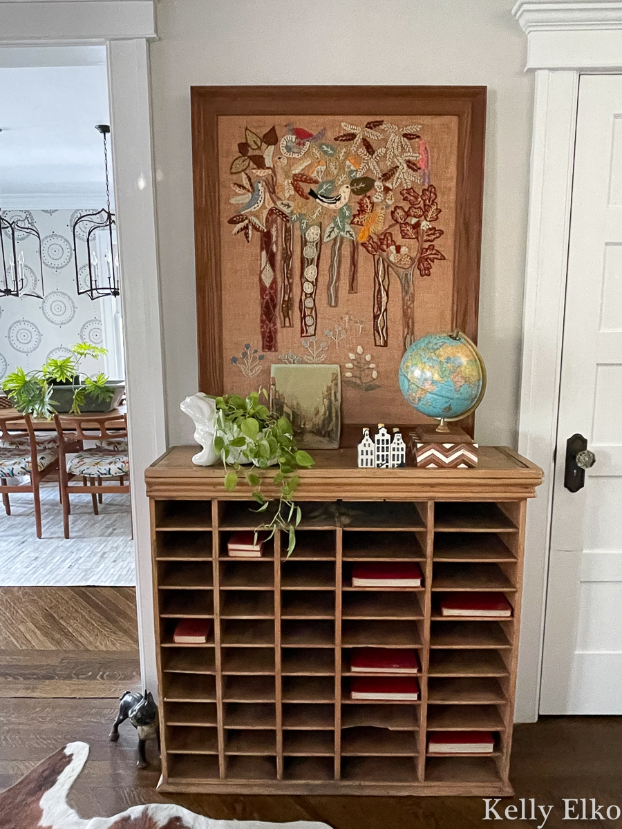 Love this vintage mail sorter and giant crewel art in this eclectic home kellyelko.com