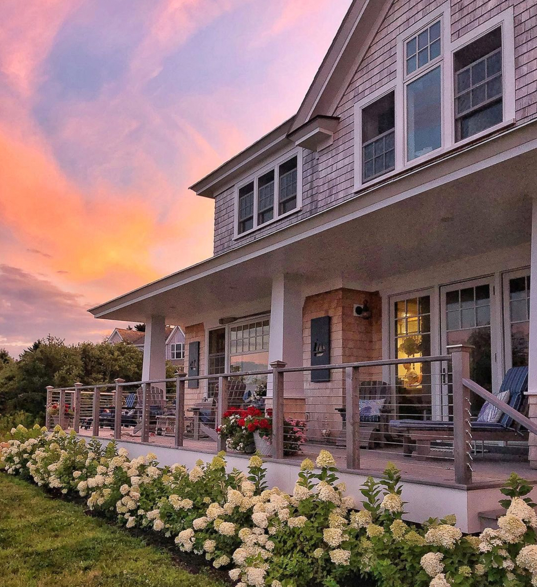 Stunning coastal home at sunset with a row of limelight hydrangeas kellyelko.com