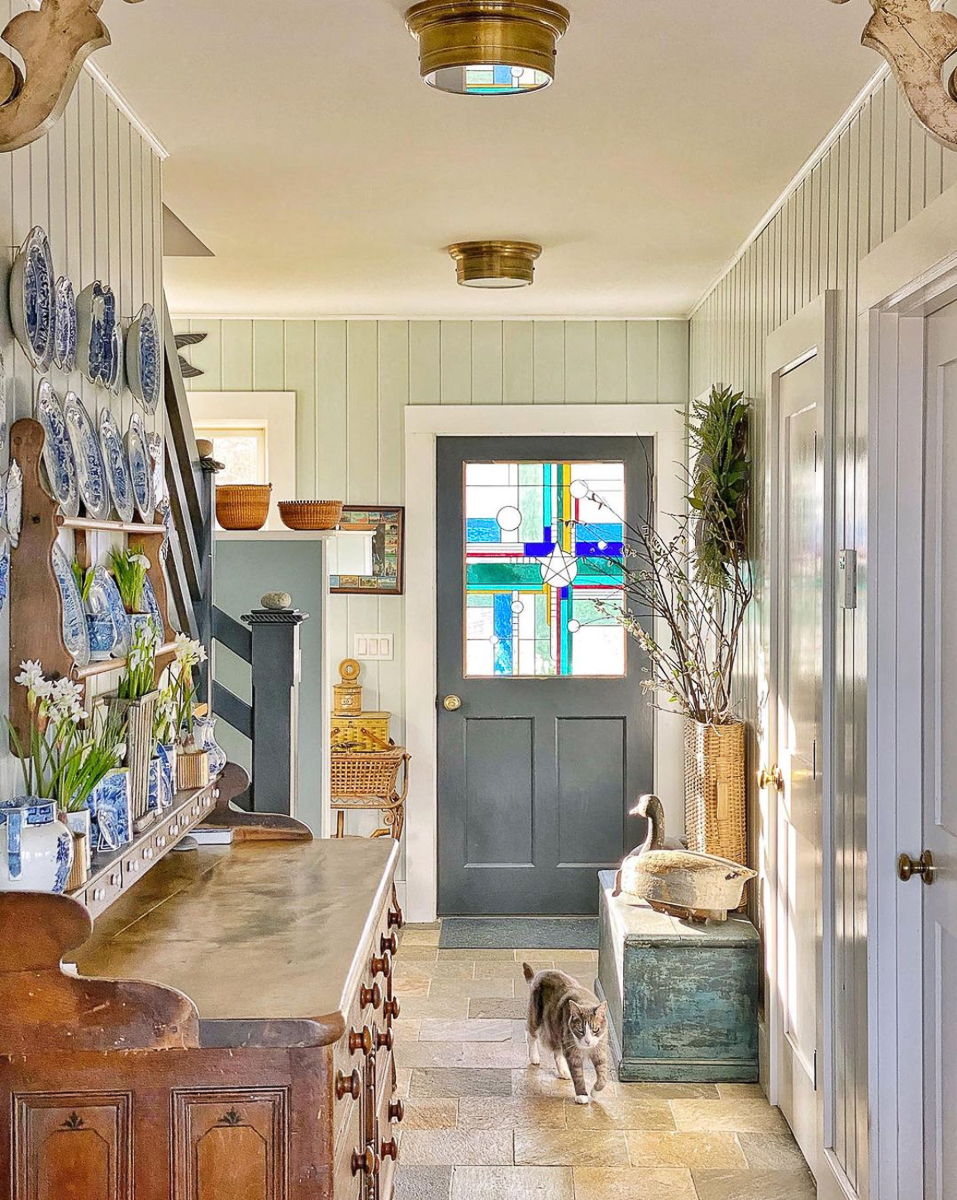 Cottage foyer with stained glass door and blue and white plate collection kellyelko.com