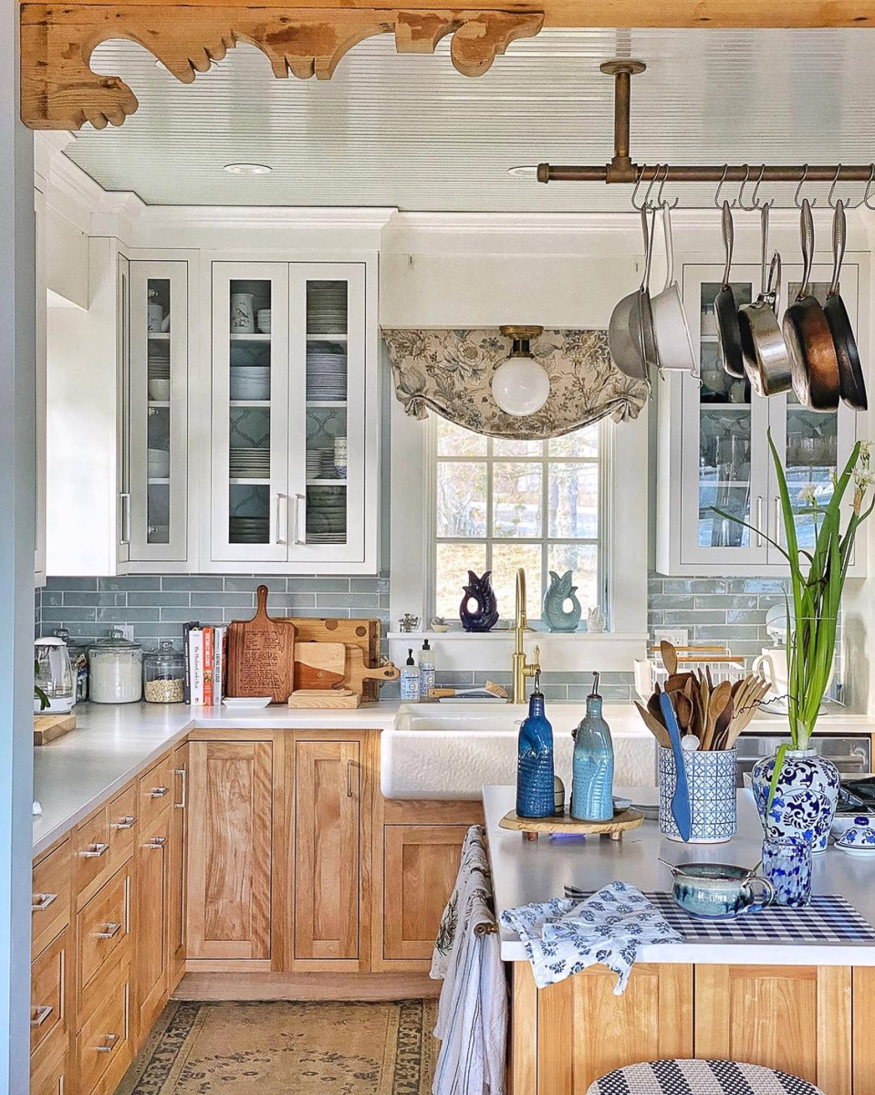 Eclectic Home Tour Molly in Maine - love this stunning farmhouse kitchen with wood lower cabinets and white uppers plus the hanging pot rack and antique corbels kellyelko.com
