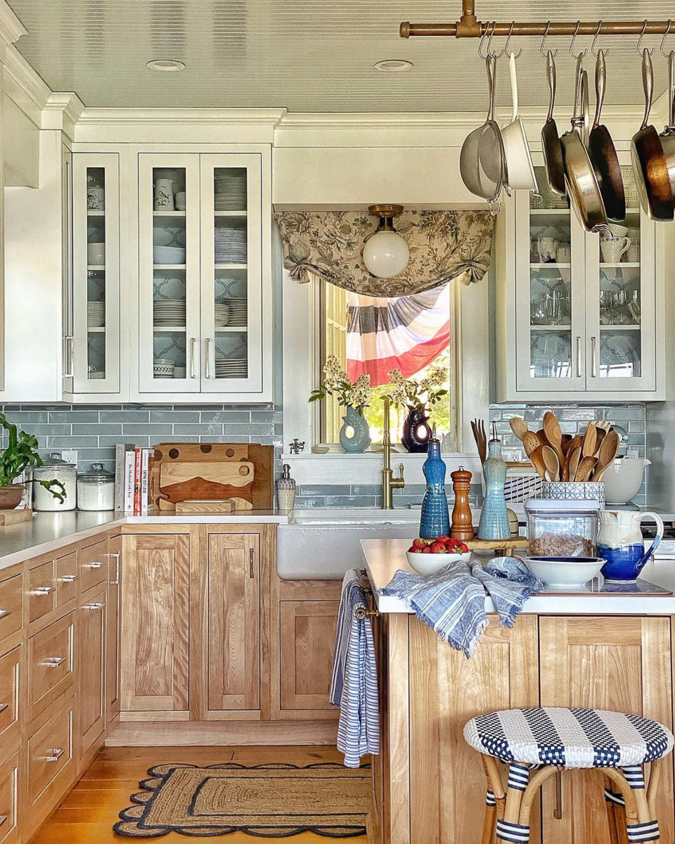 Farmhouse kitchen with natural wood cabinets with white upper cabinets kellyelko.com 