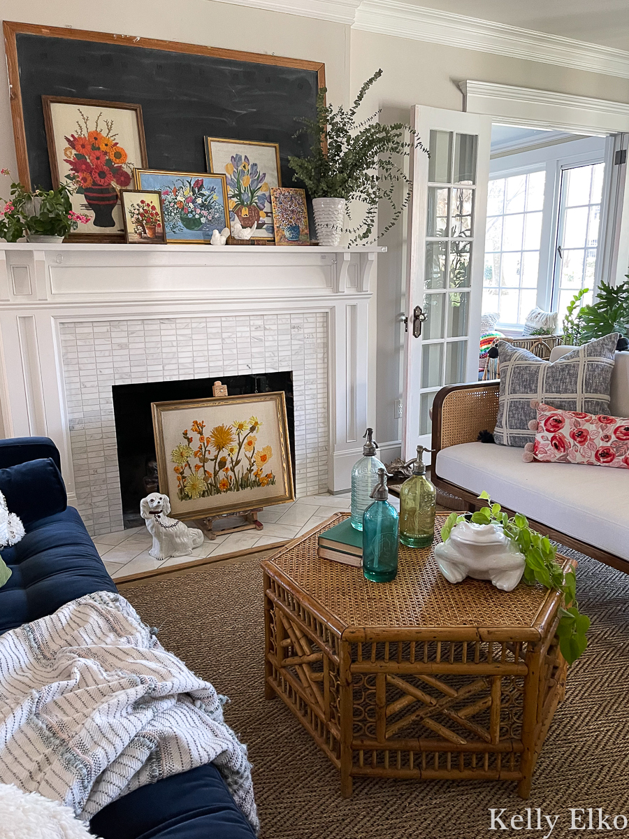 Stunning boho eclectic living room with vintage cane coffee table and vintage art kellyelko.com 