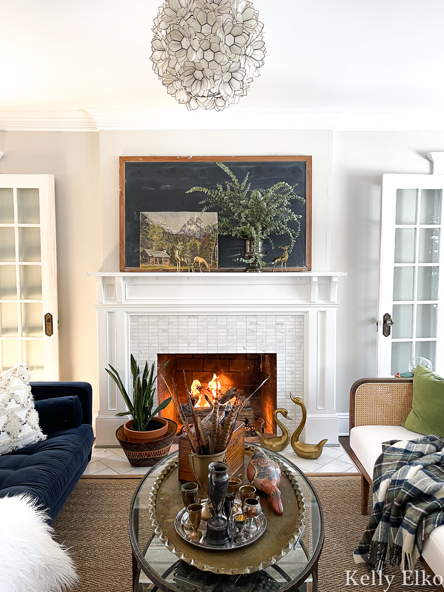 Love this winter mantel and living room and her tips on how to create an eclectic one of a kind home filled with unique treasures kellyelko.com 