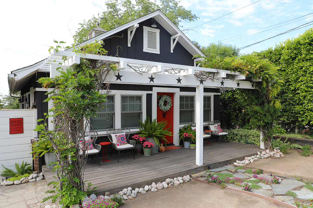 Tour this charming California bungalow - love the blue house with red door and pergola covered in vines 