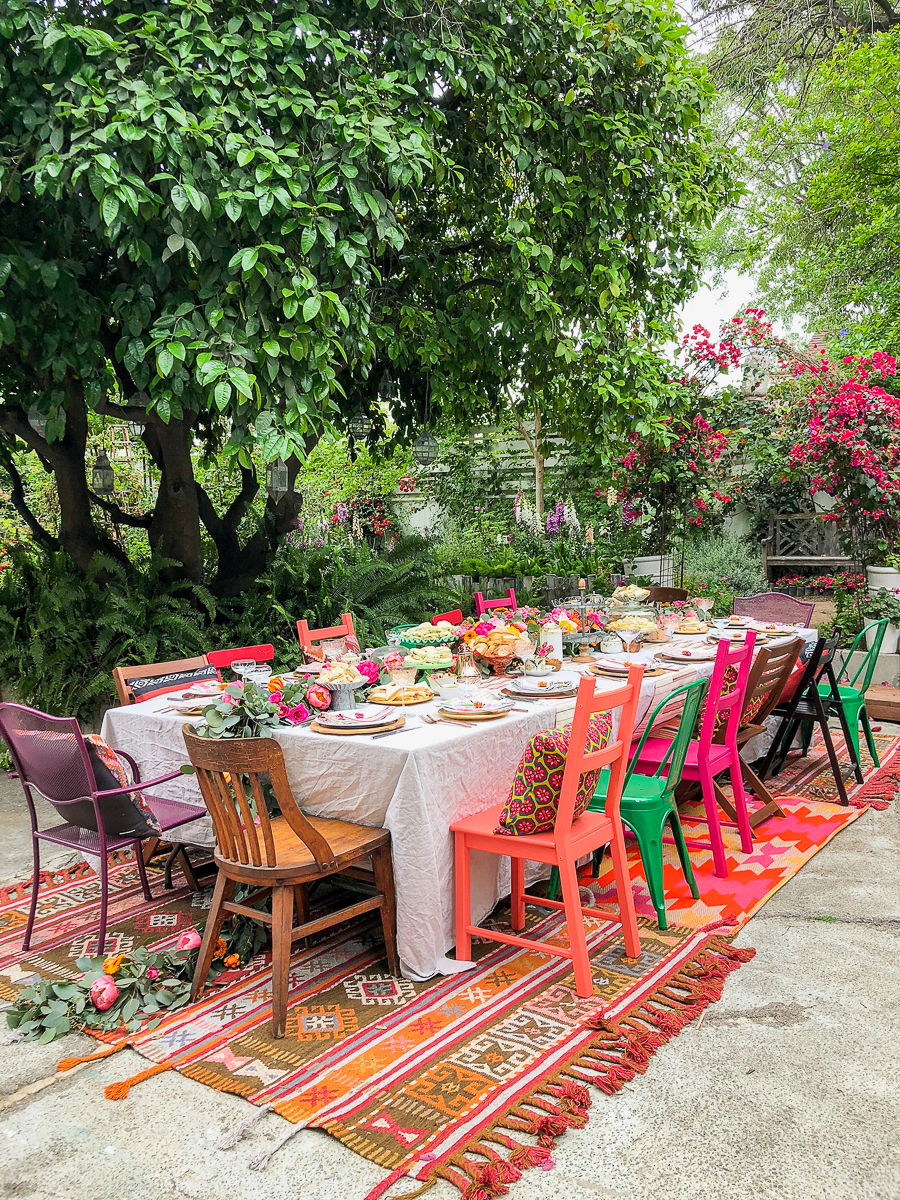 Colorful boho garden party - love the colorful chairs and mismatched rugs