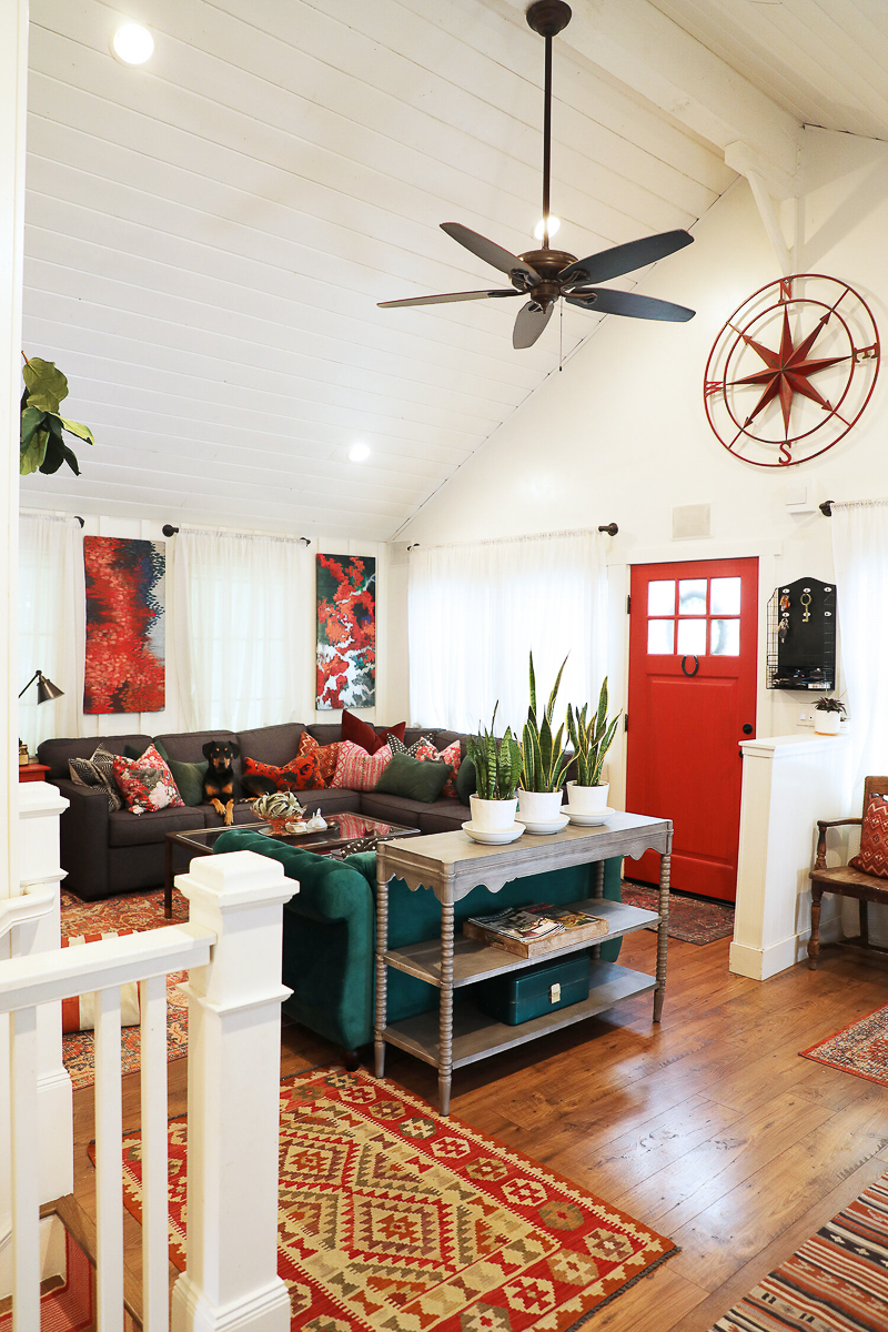 Farmhouse with soaring ceilings in shiplap and a red front door 