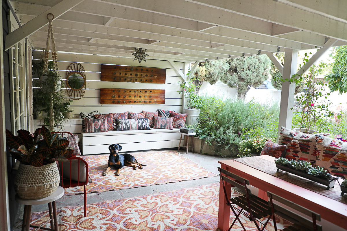 Covered patio with colorful rugs and accessories 