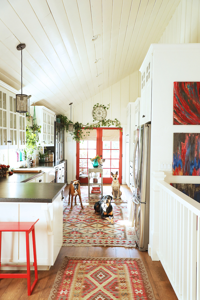 Farmhouse galley kitchen - love the red French doors 