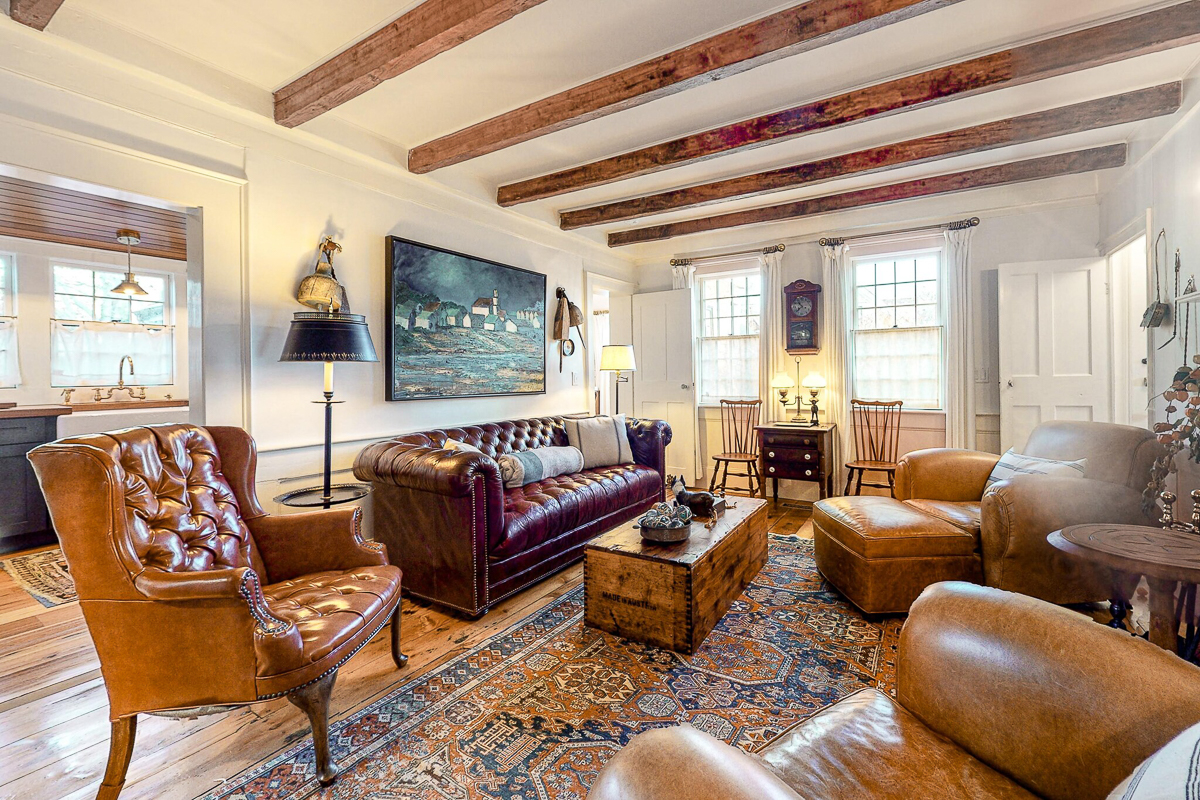 Antique home with wood ceiling beams and leather furniture 