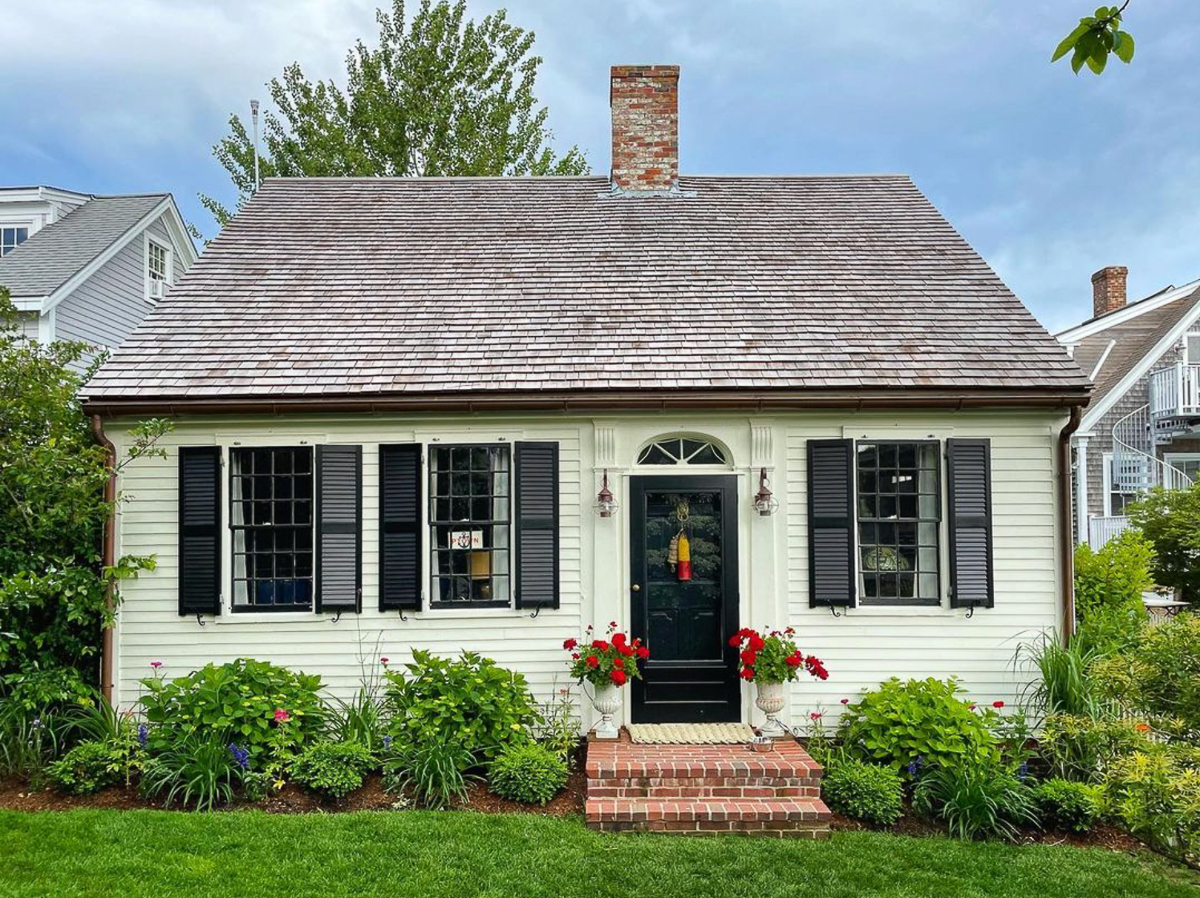 Curb appeal - love this charming little cottage white with black shutters and windows 