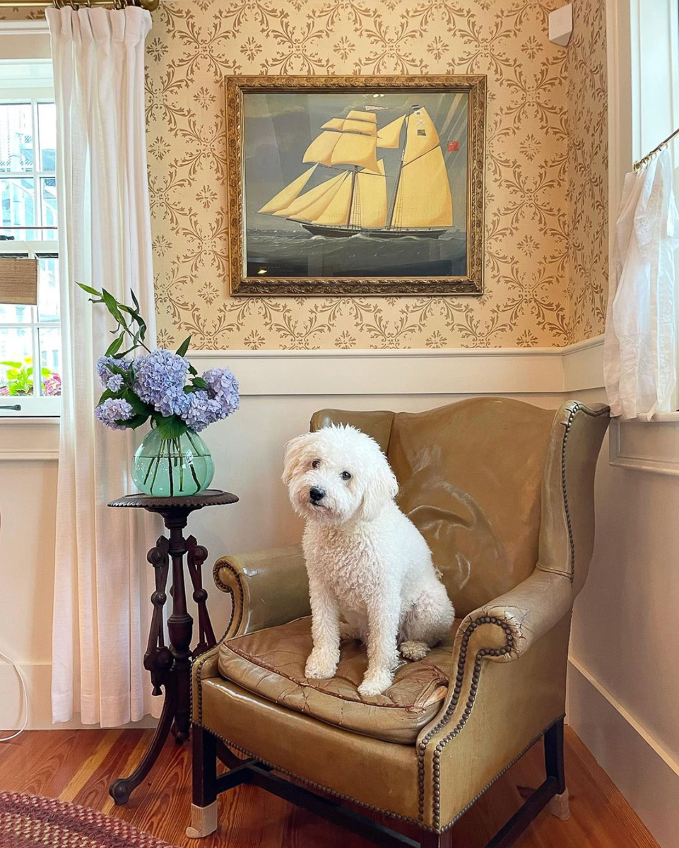 Coastal home with ship art and leather wingback chair