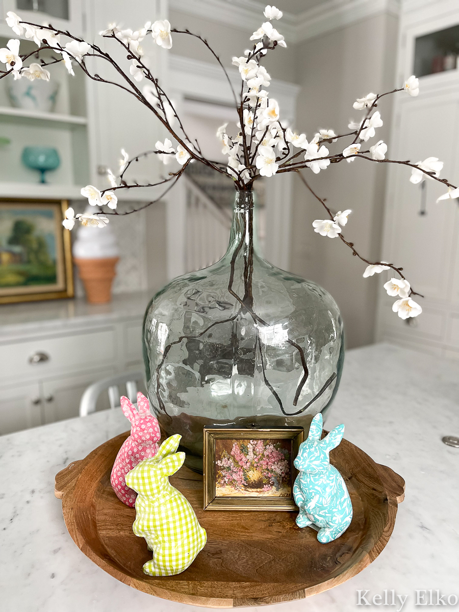 Spring decor in the kitchen - love the faux flowering branches and colorful little bunnies kellyelko.com