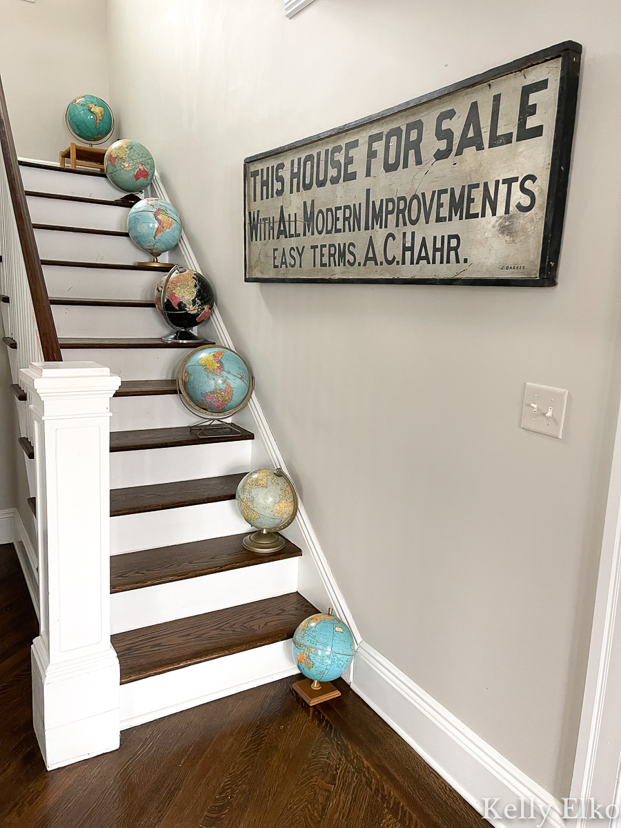 Vintage Globes! Love the fun way they are displayed on the stairs kellyelko.com