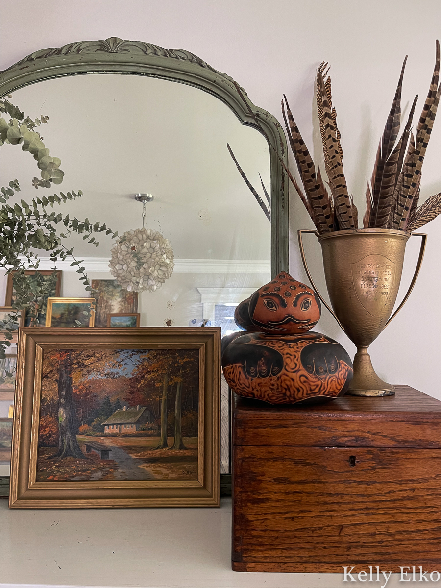 Fall Mantel Decorating Ideas - love this vintage fall mantel using baskets, plants, art, mirrors, feathers and gourds kellyelko.com