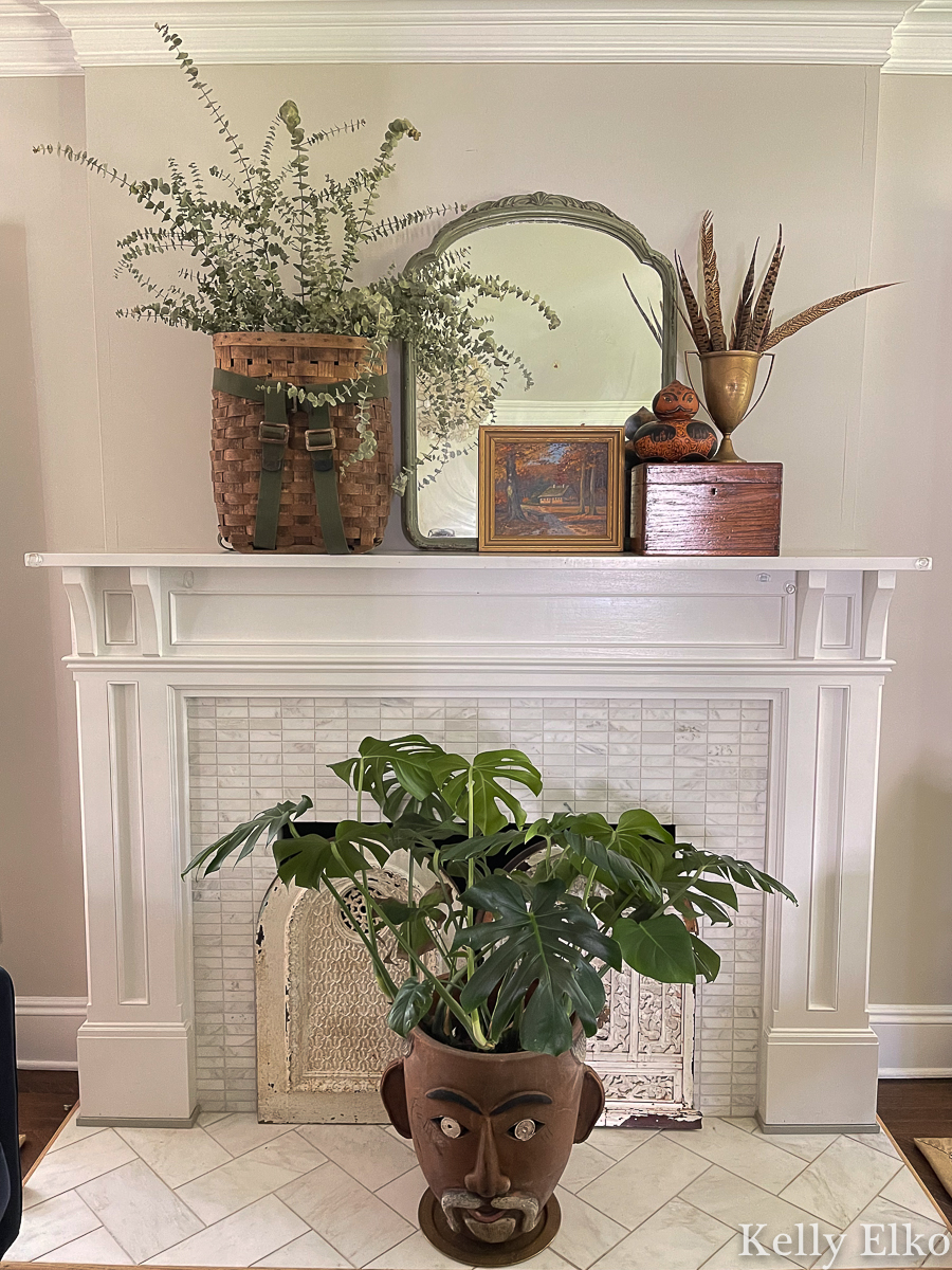 Fall Mantel Decorating Ideas - love this vintage fall mantel using baskets, plants, art, mirrors, feathers and gourds kellyelko.com