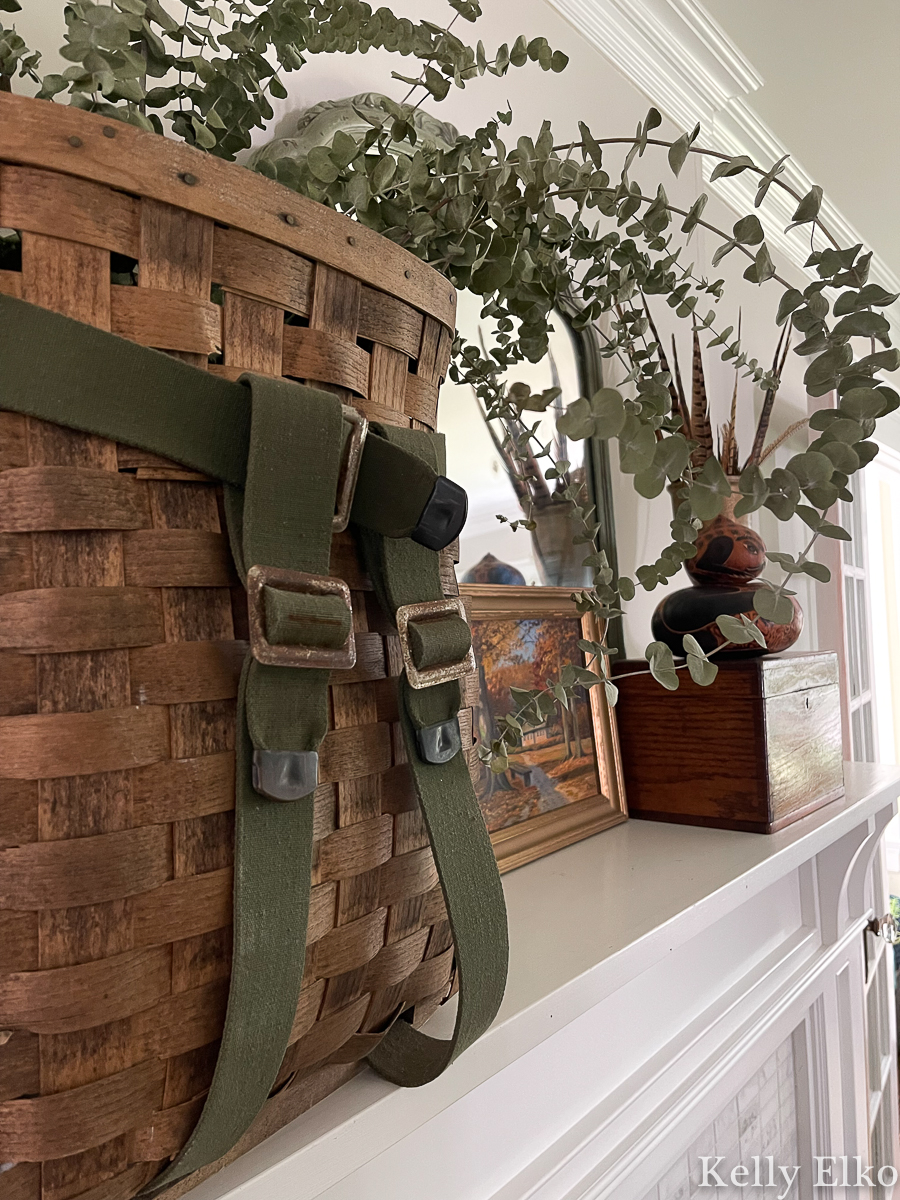 Fall Mantel Decorating Ideas - love this vintage fall mantel using baskets, plants, art, mirrors, feathers and gourds kellyelko.com