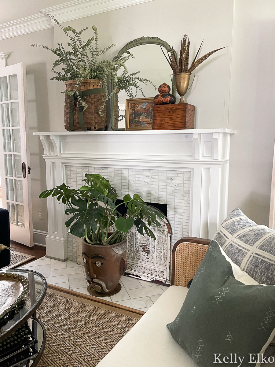 Fall Mantel Decorating Ideas - love this vintage fall mantel using baskets, plants, art, mirrors, feathers and gourds kellyelko.com