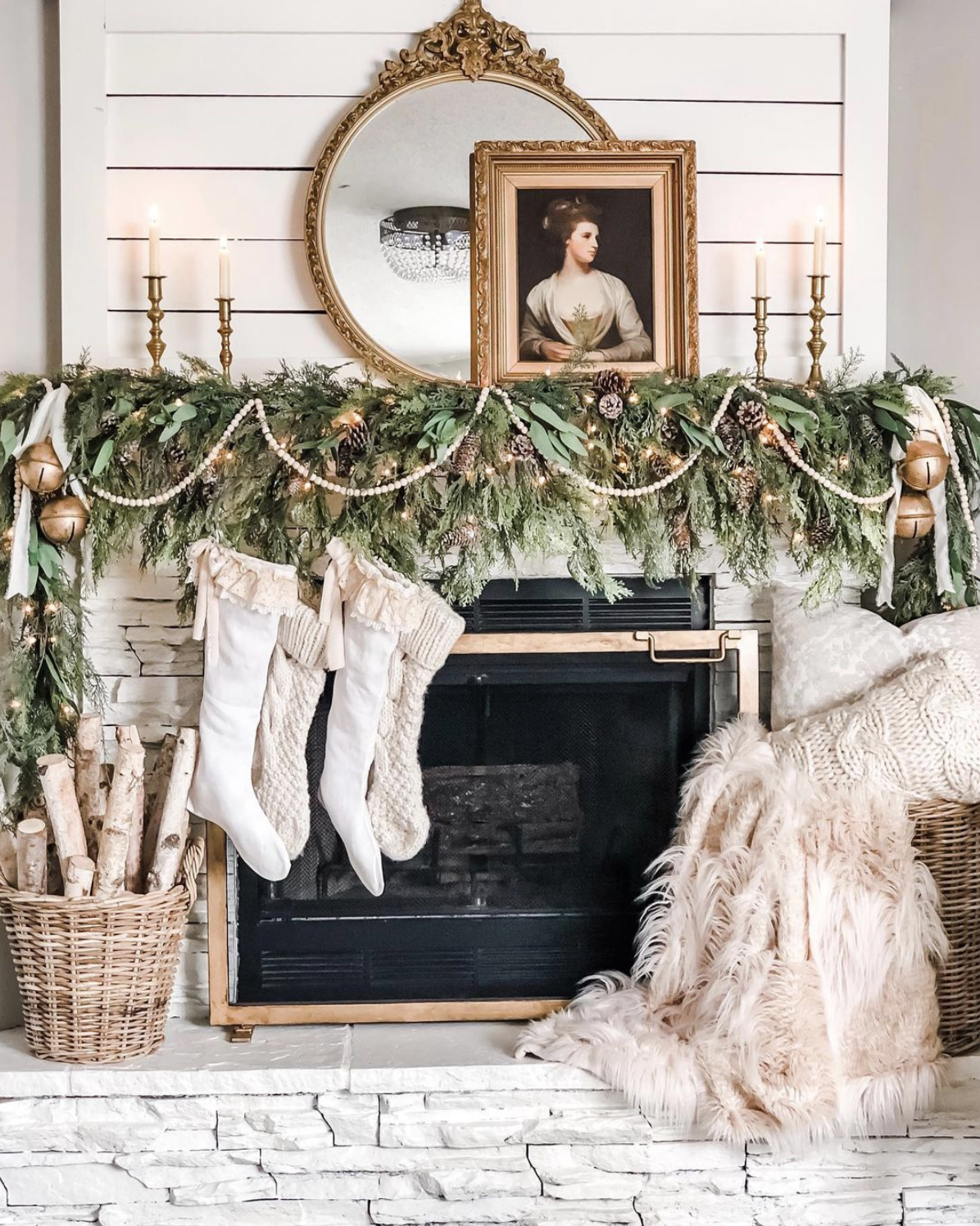 10 Stunning Christmas Mantels - love this antique portrait mantel with chunky knit stockings and green garland 