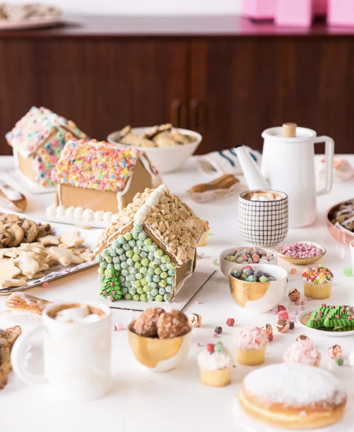 Throw a gingerbread house decorating party and use colorful cereal to decorate them 