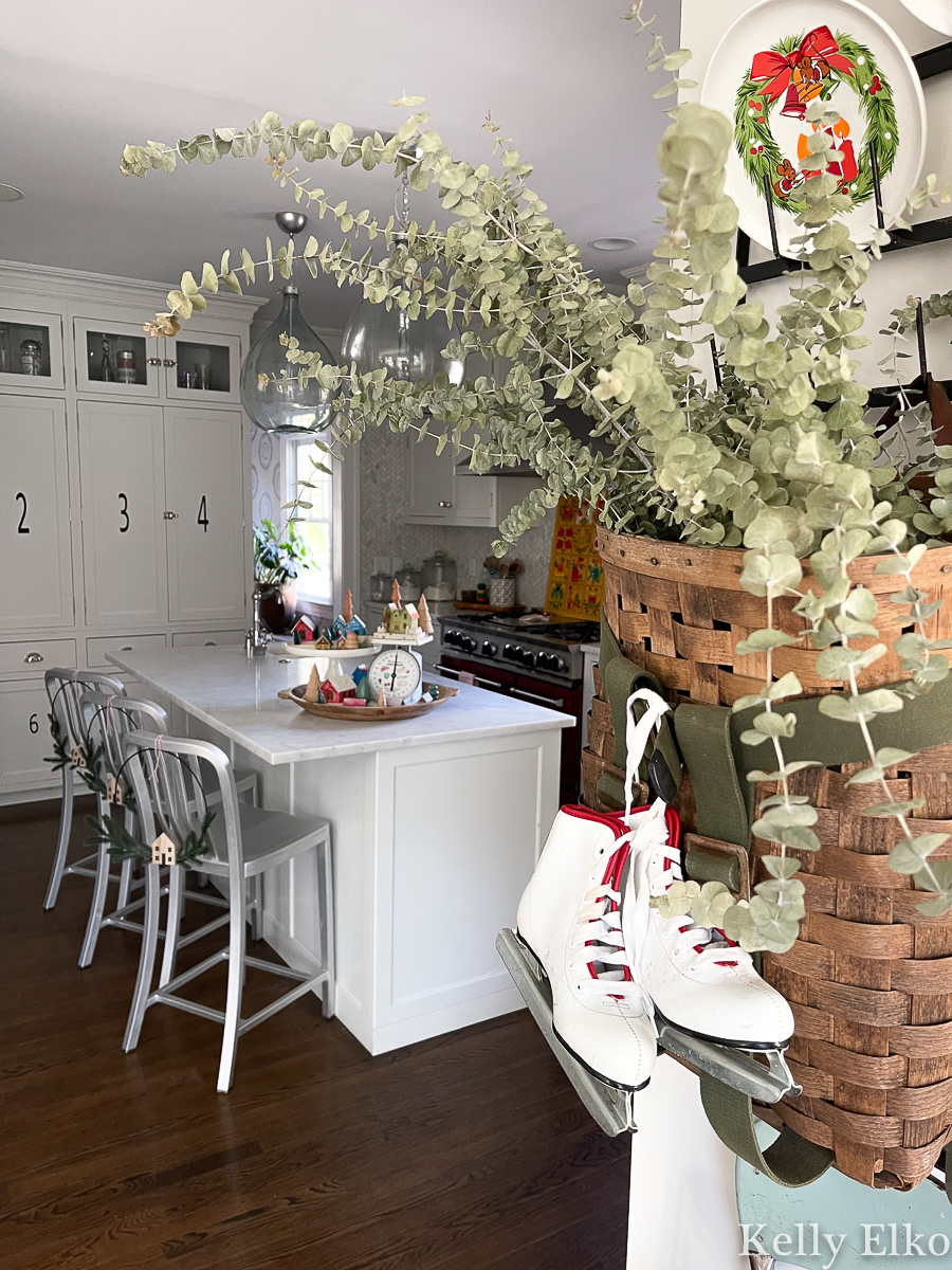 Christmas kitchen - love the huge basket filled with eucalyptus and ice skates kellyelko.com