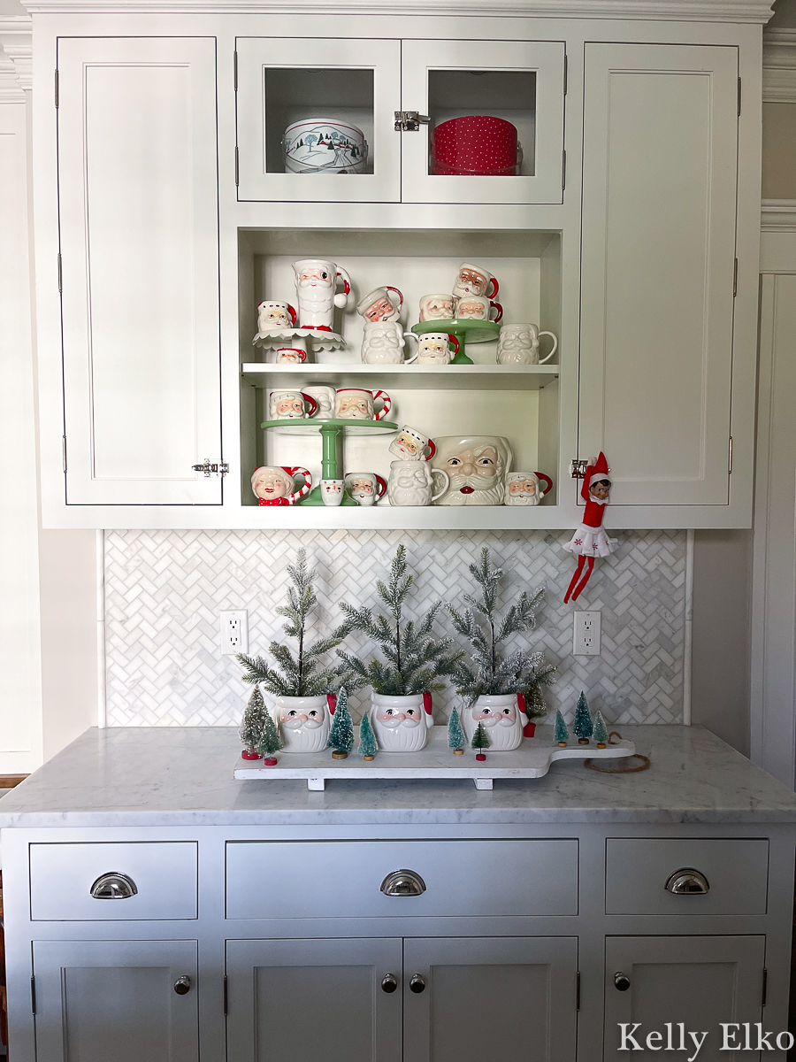 Love this Santa mug collection and the way it's displayed in this white kitchen kellyelko.com