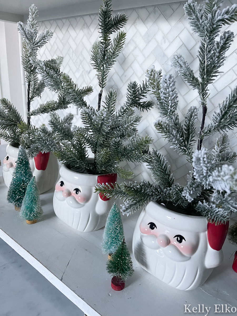 Santa planters holding tiny feather trees kellyelko.com