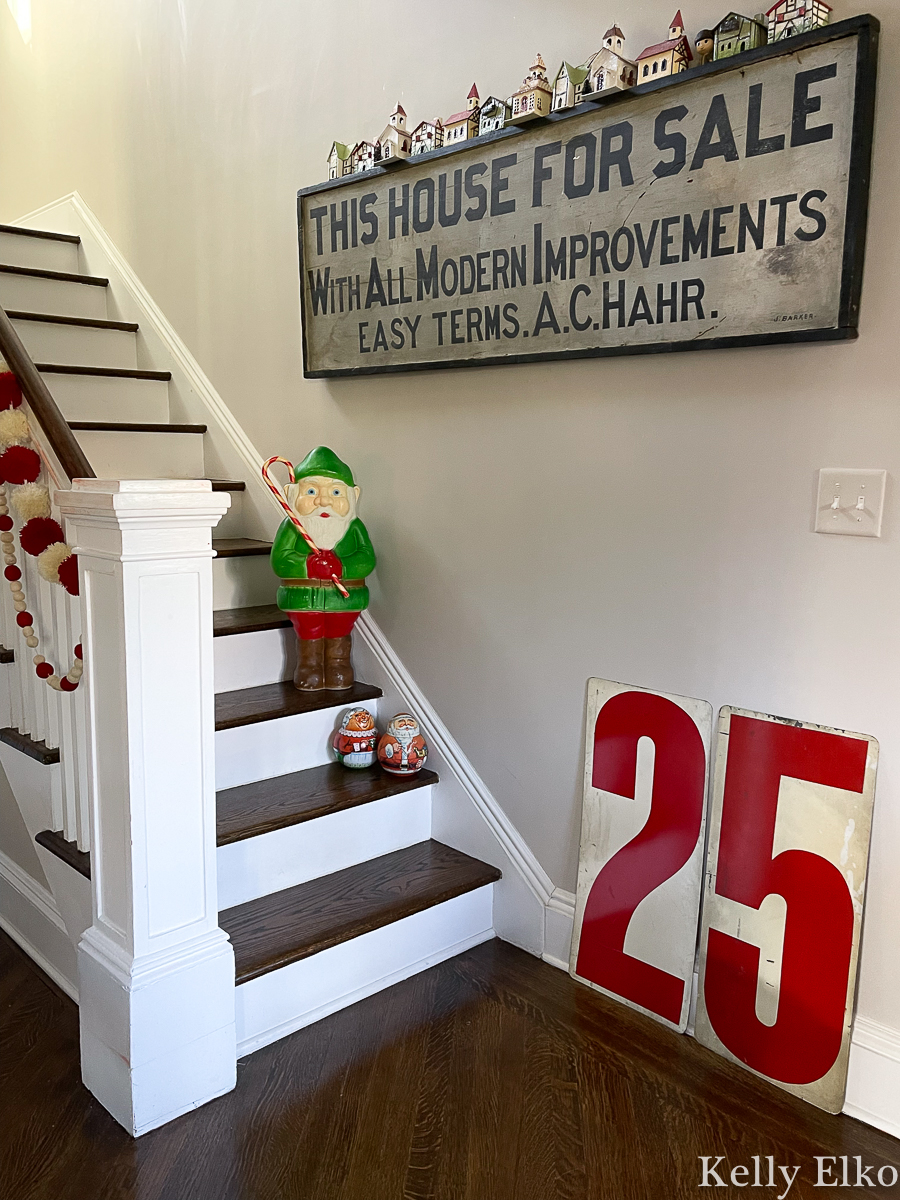 Christmas stairs with antique sign, vintage blow mold and little houses kellyelko.com