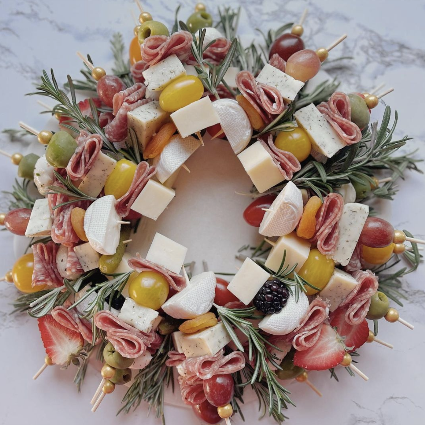 Love this festive charcuterie board wreath with individual skewers 