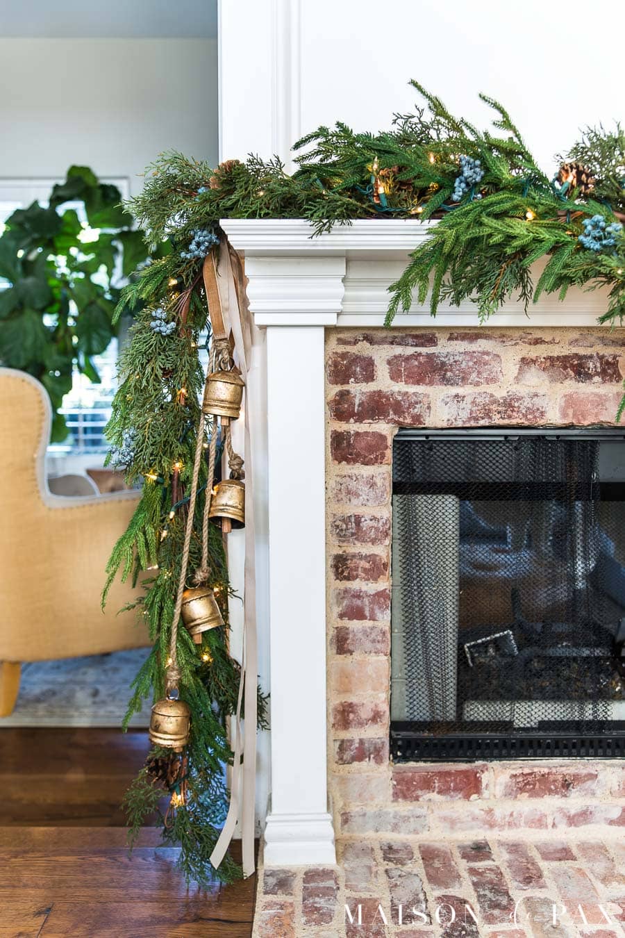 Love this Christmas mantel with cascading brass bells 