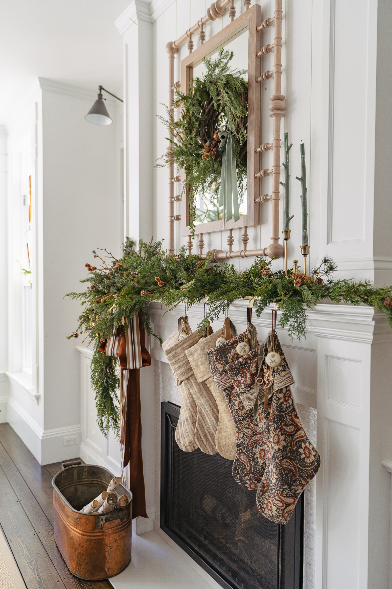 Stunning Christmas mantel with asymmetrical garland and vintage stockings