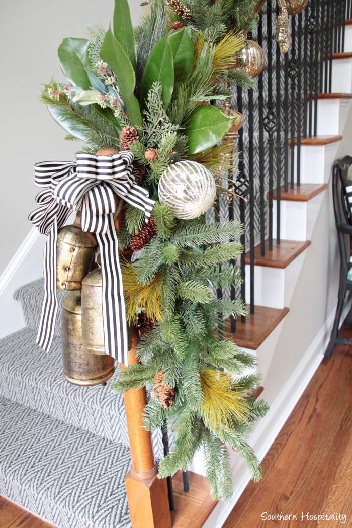 Christmas bannister with magnolia leaves and brass bells