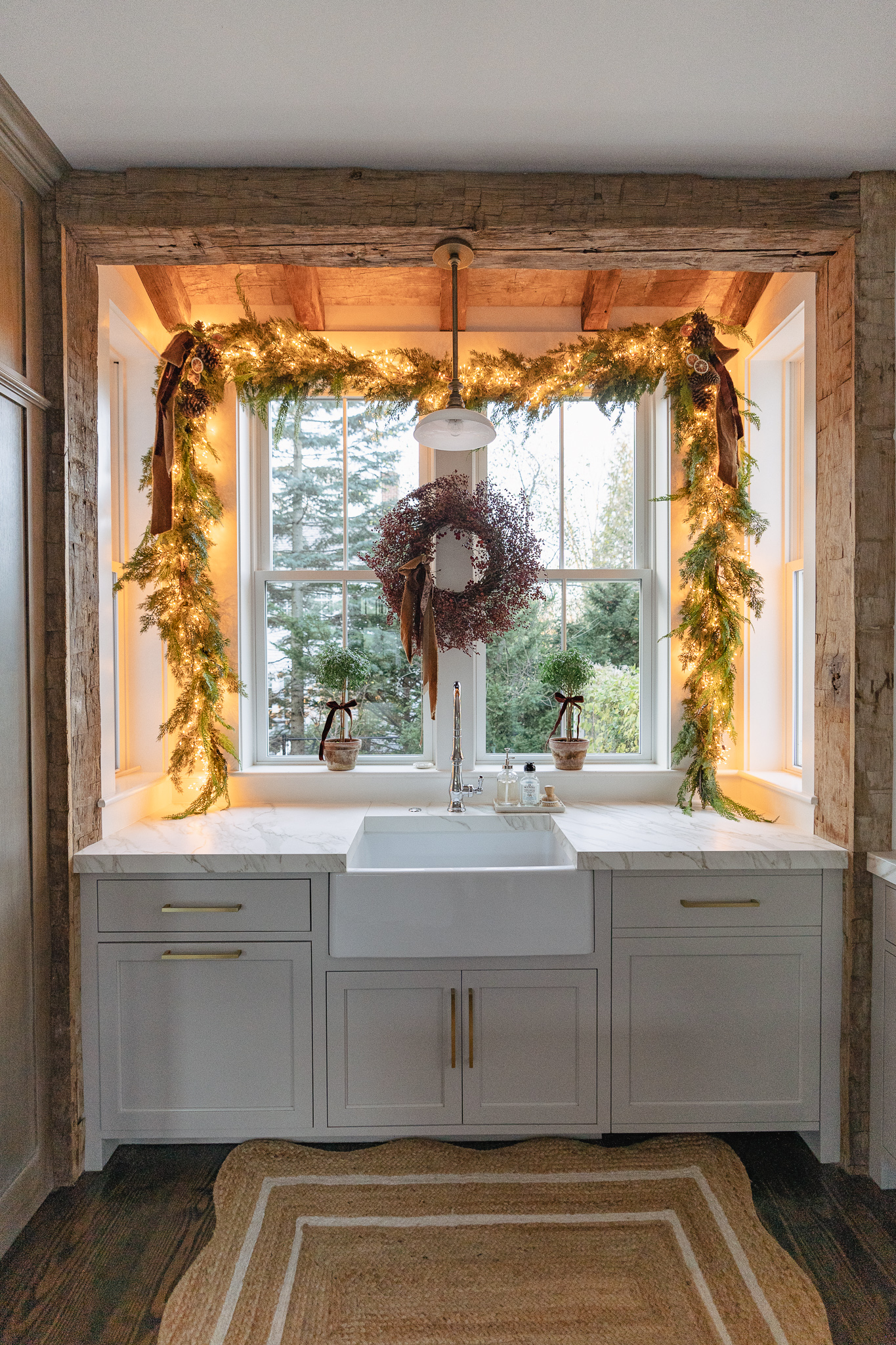 Love this kitchen sink with exposed wood beams and beautiful Christmas garland 