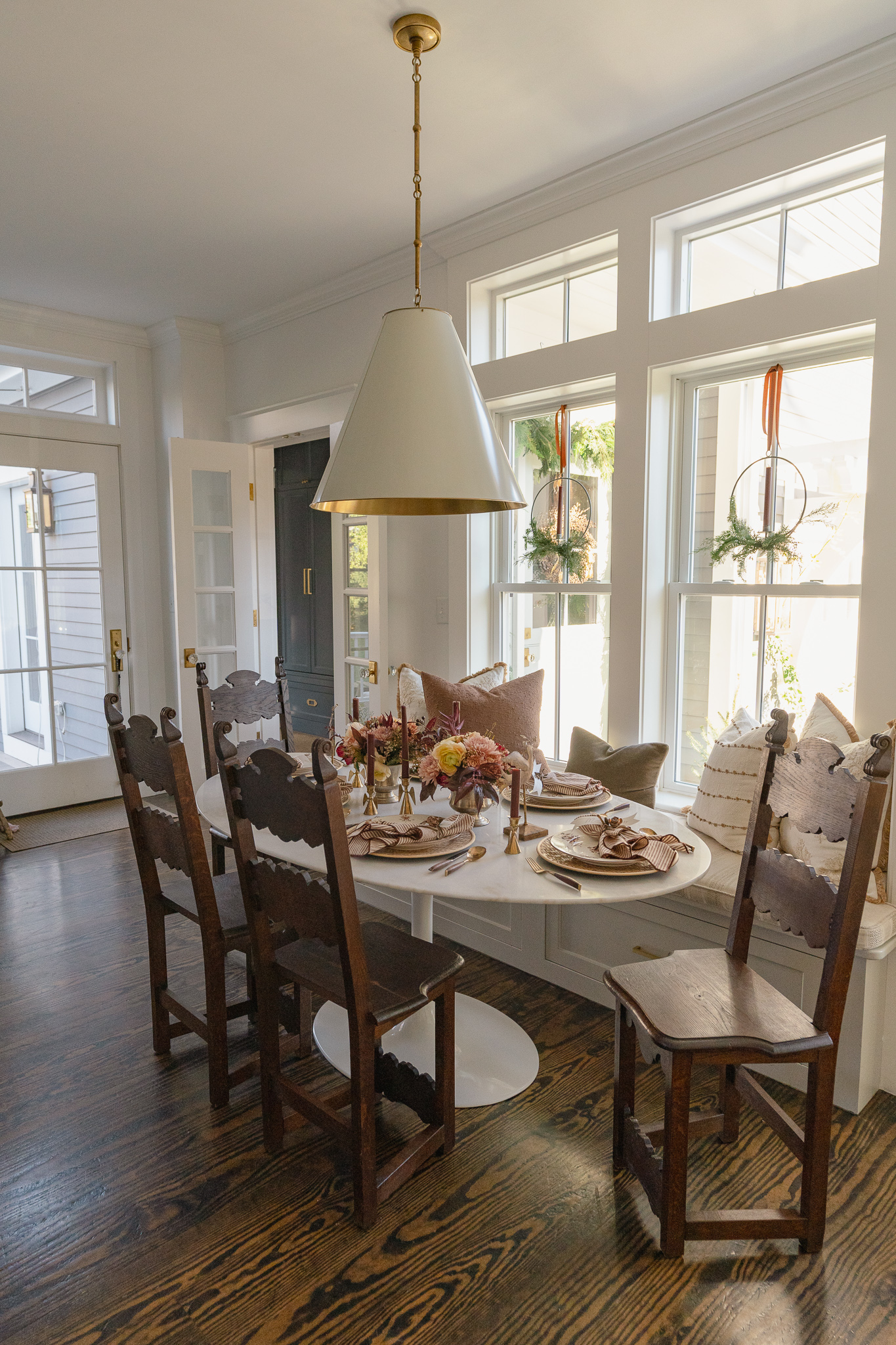 Antique wood chairs and a modern Saarinen oval table 