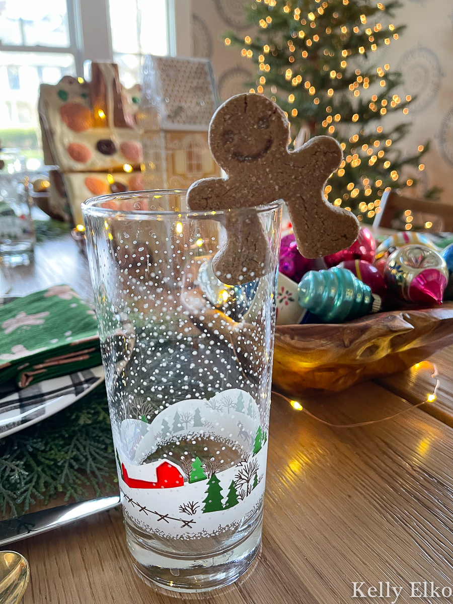 Vintage Christmas snowy scene with red barn drinking glasses with a gingerbread man mug topper kellyelko.com