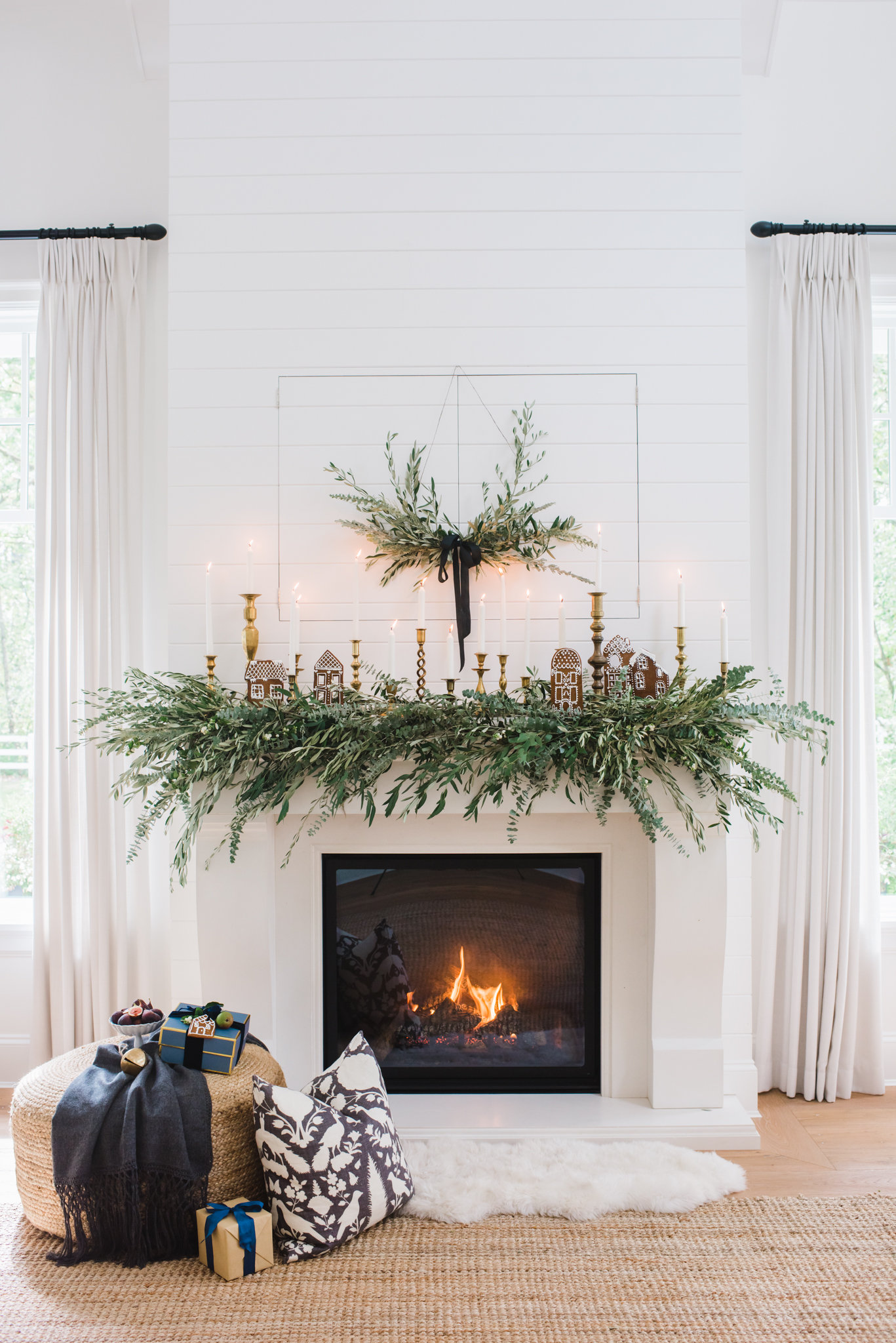Love this cute little gingerbread house Christmas mantel with vintage brass candlesticks and the mix of greenery