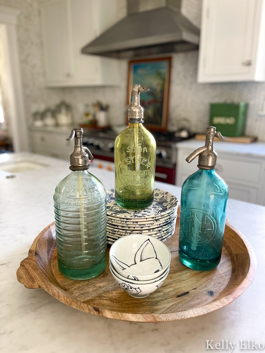Trio of vintage blue and green seltzer bottles in a white kitchen kellyelko.com