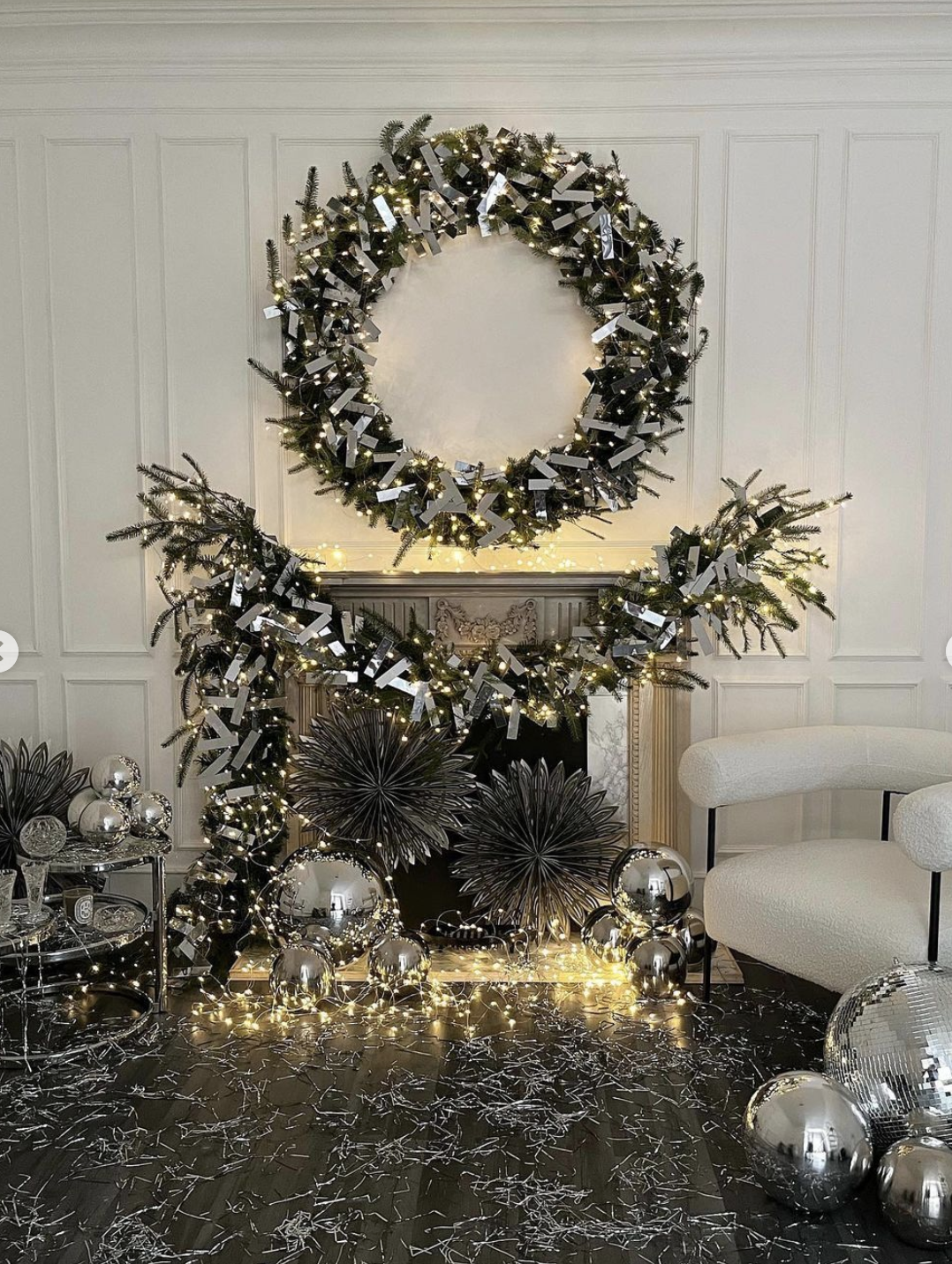 Disco Christmas mantel with mirrored garland on wreath and disco balls on hearth / kellyelko.com