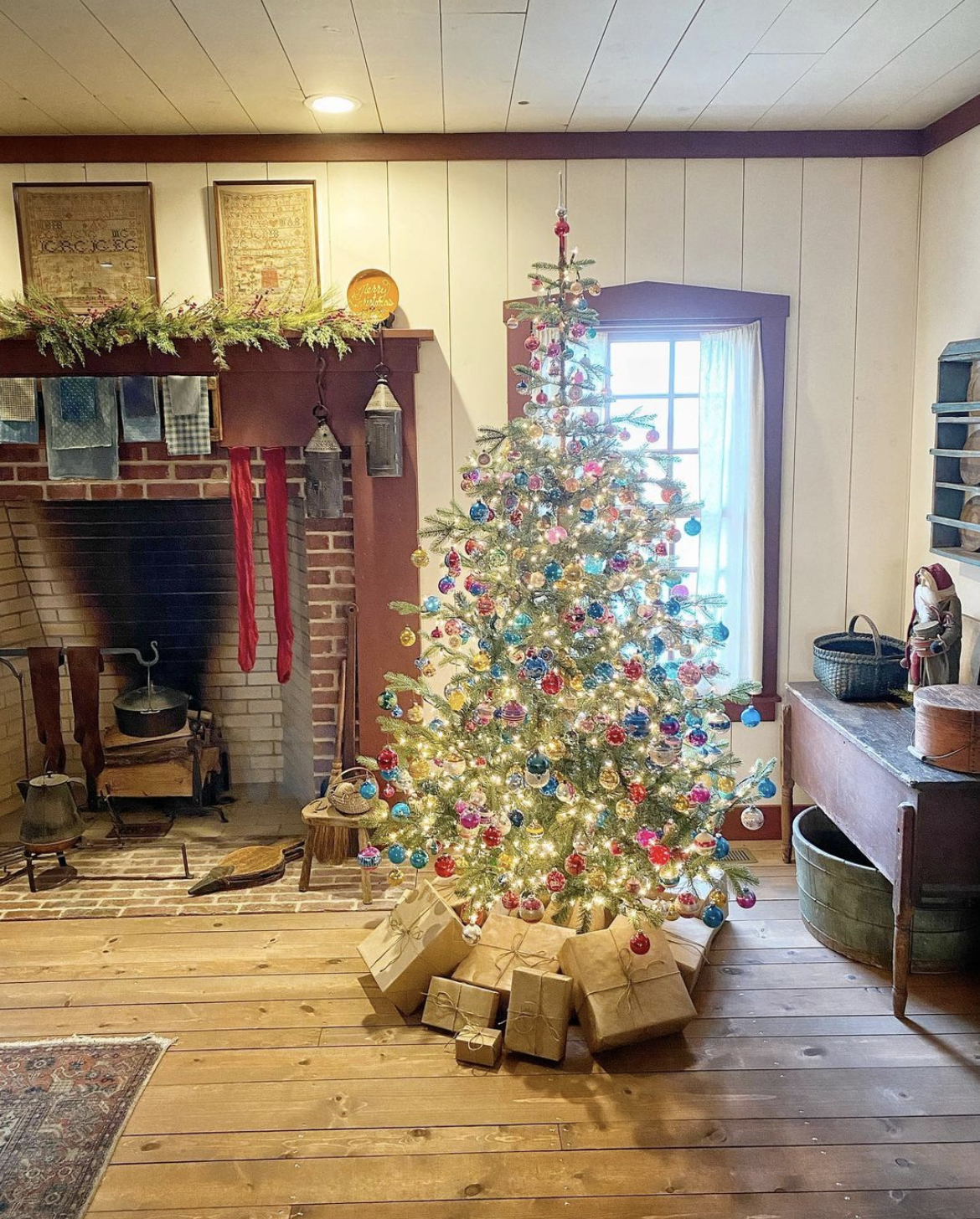 Old fashioned Christmas tree with vintage Shiny Brite ornaments and brown paper packages tied up with string / kellyelko.com