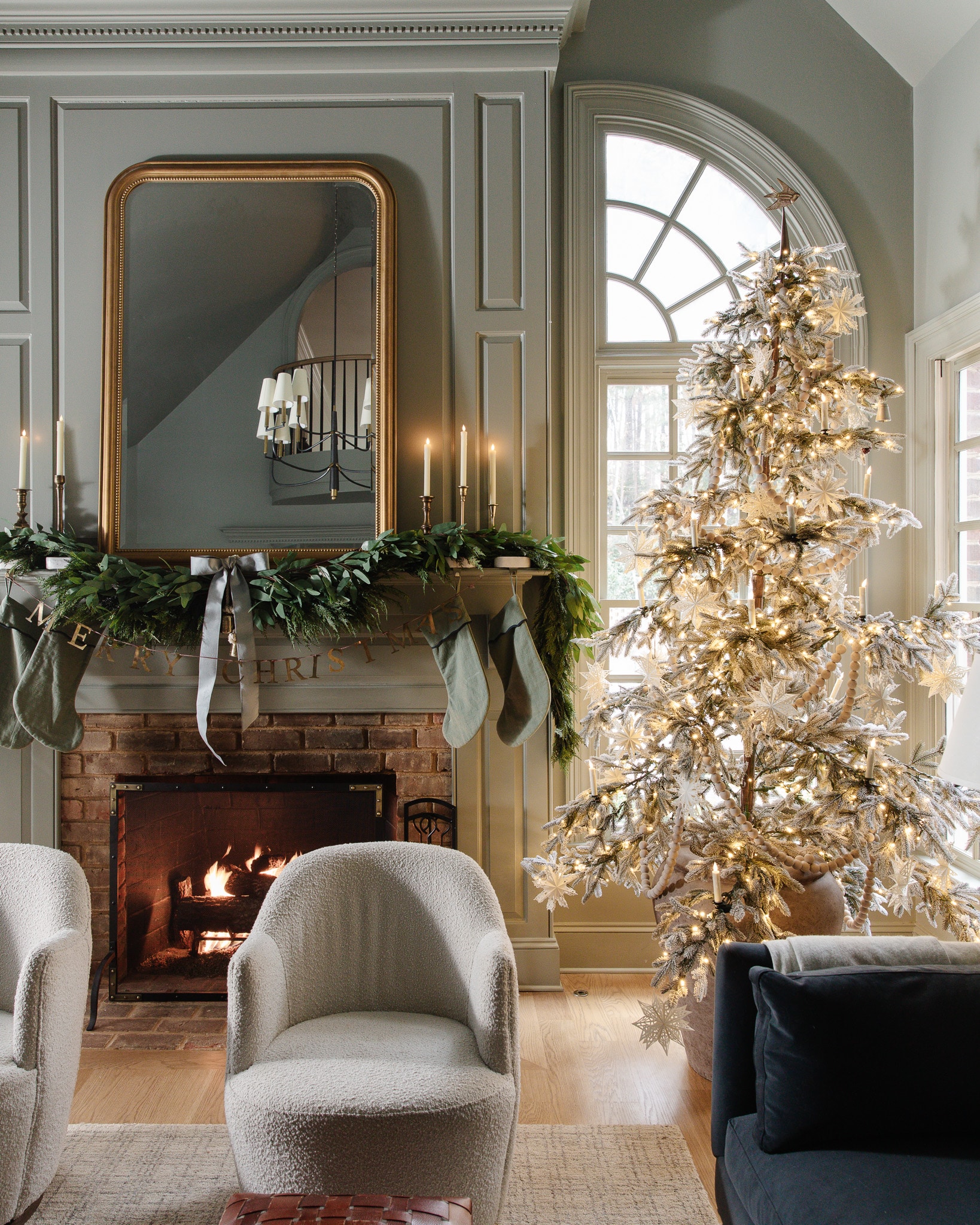 Stunning sparse Christmas tree flocked with white ornaments