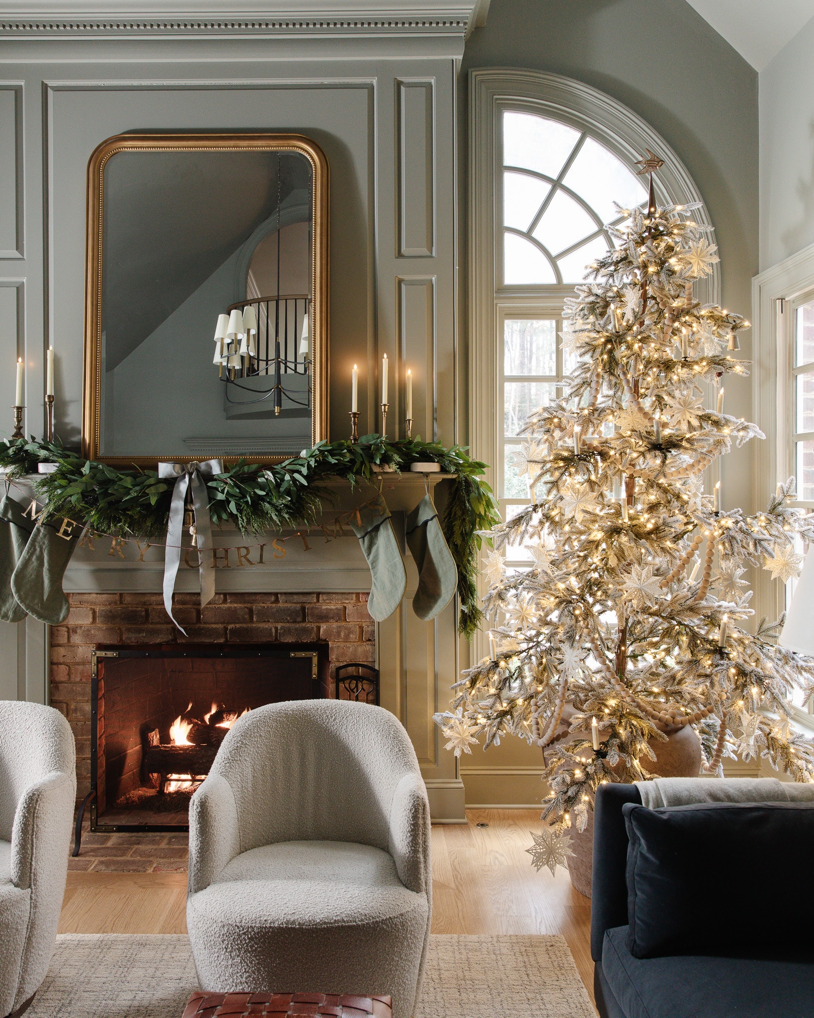 Stunning sparse Christmas tree flocked with white ornaments 