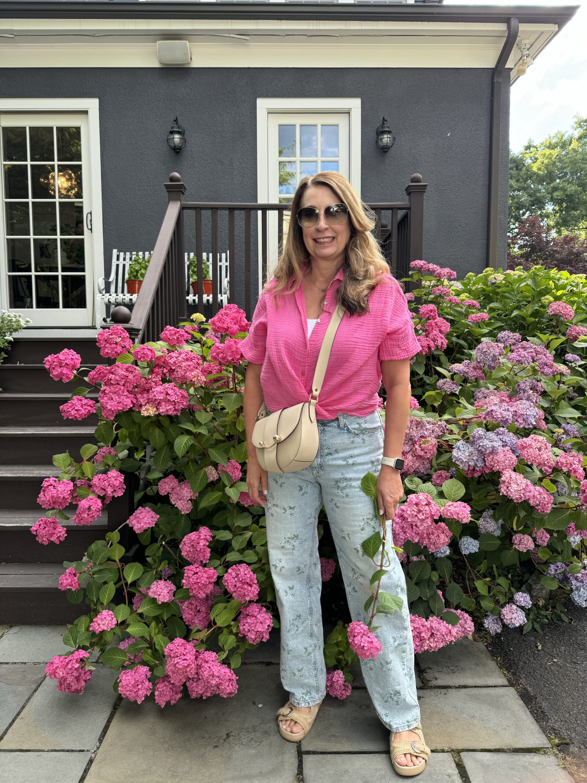 Kelly Elko in front of a gorgeous row of hydrangeas / kellyelko.com