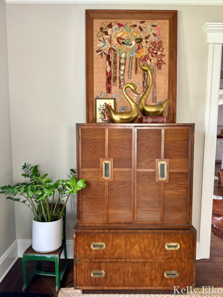 Beautiful mid century vintage campaign cabinet styled with vintage art and brass / kellyelko.com