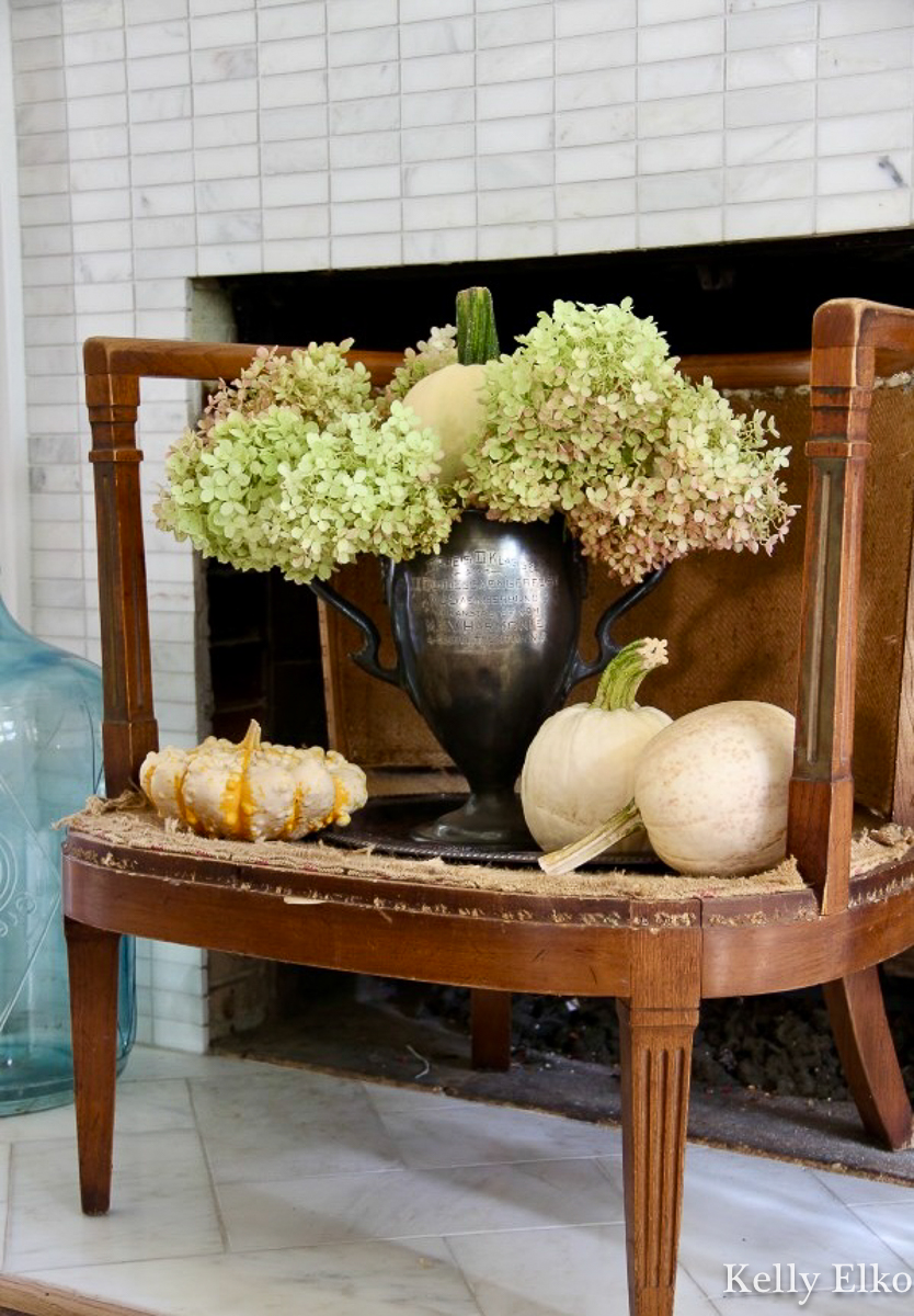Antique silver loving cup with hydrangeas and pumpkins for fall / kellyelko.com