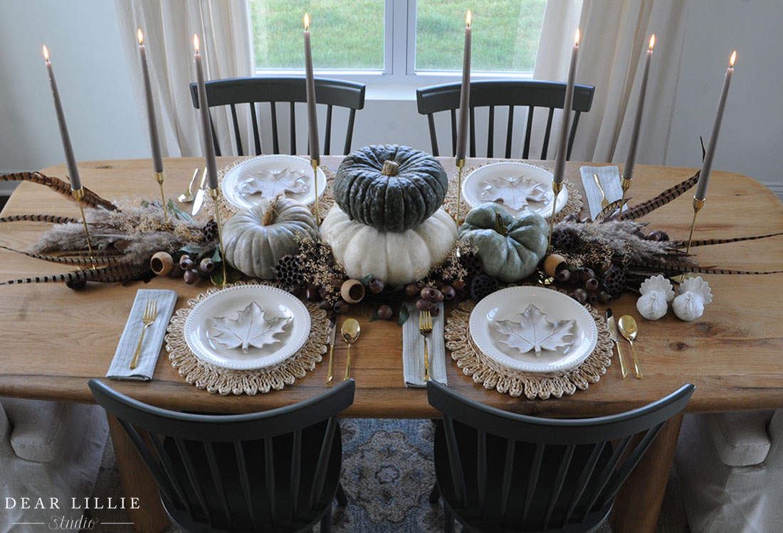 Fall centerpiece of pumpkins, feathers and candles / kellyelko.com